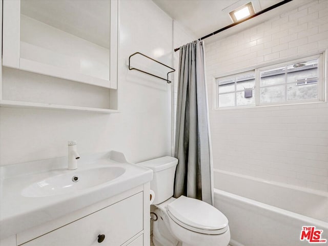 full bathroom with vanity, toilet, and shower / bath combo with shower curtain