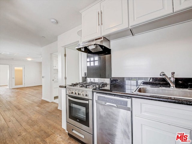 kitchen with white cabinetry, appliances with stainless steel finishes, sink, and light wood-type flooring