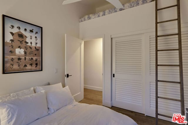 bedroom featuring hardwood / wood-style flooring and a closet