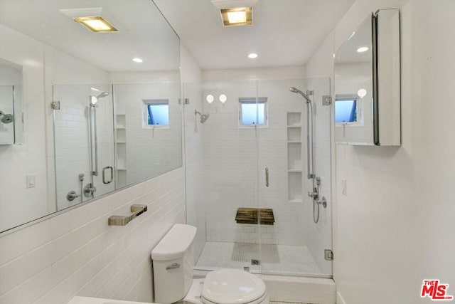 bathroom with toilet and walk in shower