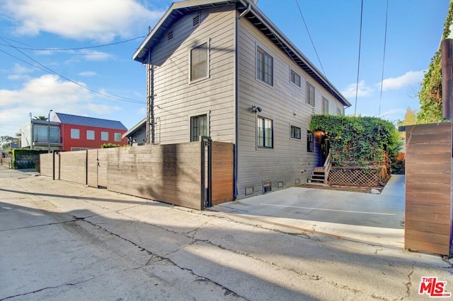 view of side of home with a patio area