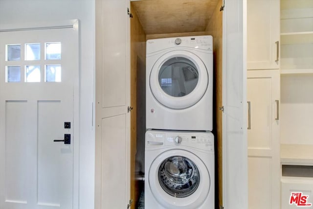 laundry room featuring stacked washer and clothes dryer