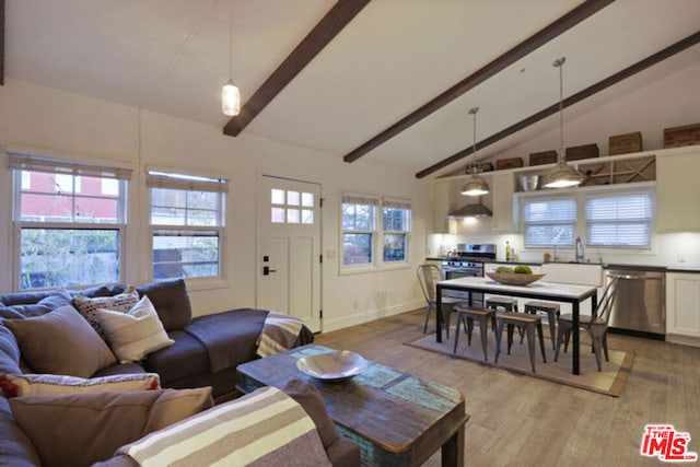 living room featuring beamed ceiling, sink, hardwood / wood-style floors, and high vaulted ceiling