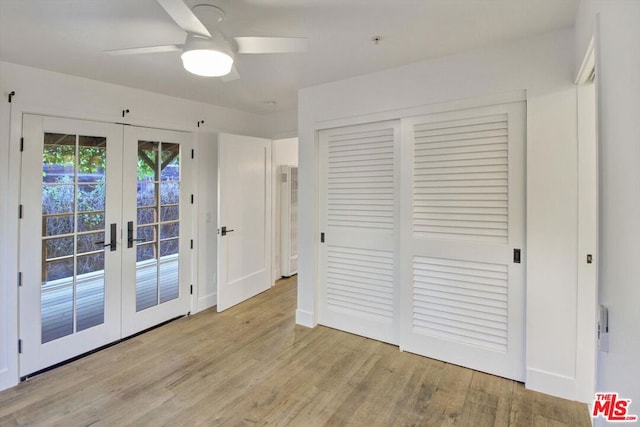 unfurnished bedroom with ceiling fan, access to exterior, light hardwood / wood-style floors, french doors, and a closet