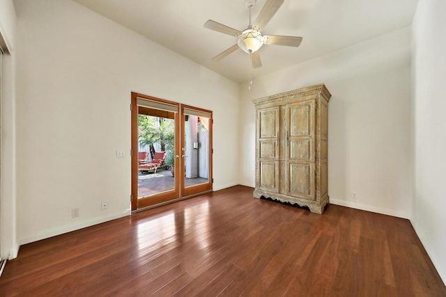 empty room with dark hardwood / wood-style floors, ceiling fan, and french doors