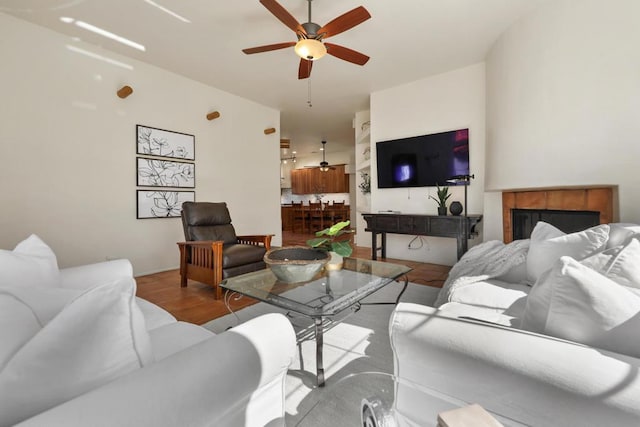 living room with ceiling fan and light wood-type flooring