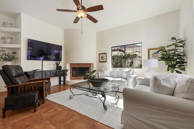 living room featuring a fireplace and ceiling fan