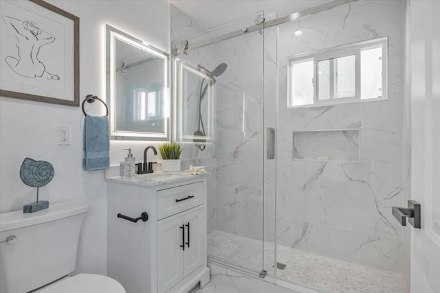 bathroom featuring walk in shower, vanity, and toilet