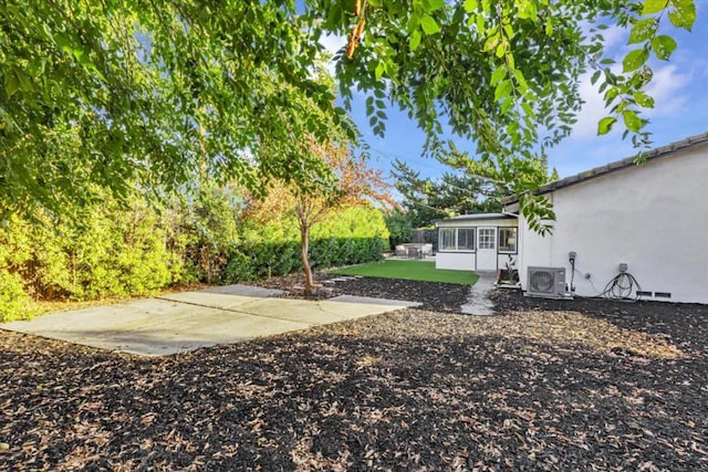 view of yard with a sunroom, ac unit, and a patio area