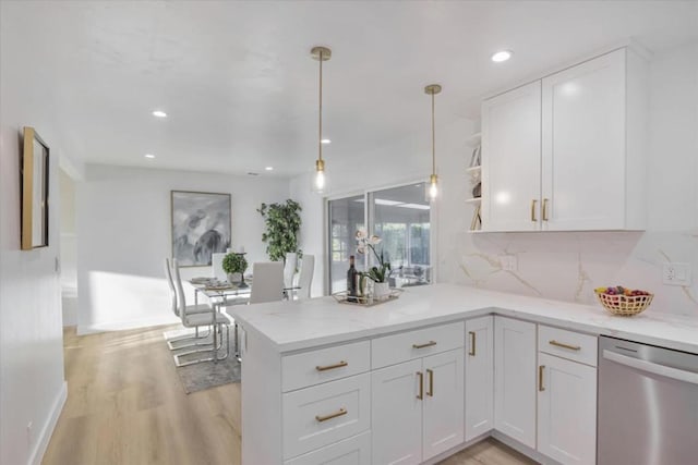 kitchen with light hardwood / wood-style flooring, dishwasher, kitchen peninsula, white cabinets, and backsplash