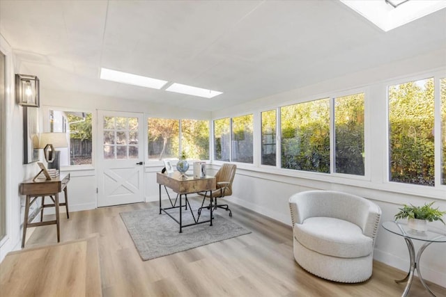 sunroom with plenty of natural light and a skylight