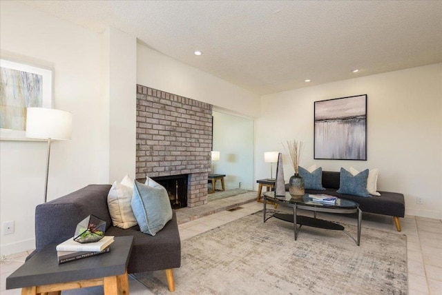 living room with light tile patterned flooring, a brick fireplace, and a textured ceiling