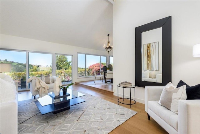 living room featuring an inviting chandelier, plenty of natural light, and wood-type flooring