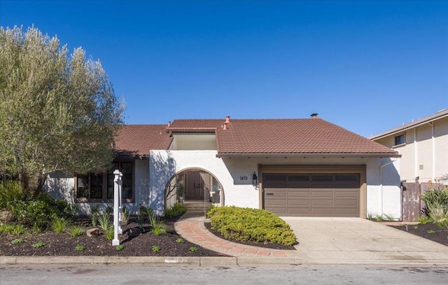 mediterranean / spanish home featuring a garage