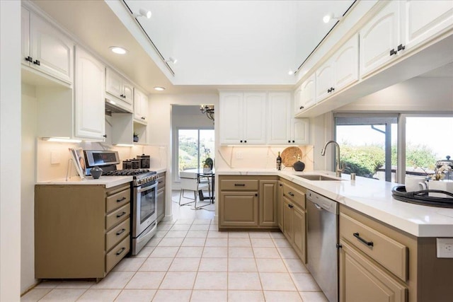 kitchen featuring tasteful backsplash, sink, light tile patterned floors, and appliances with stainless steel finishes