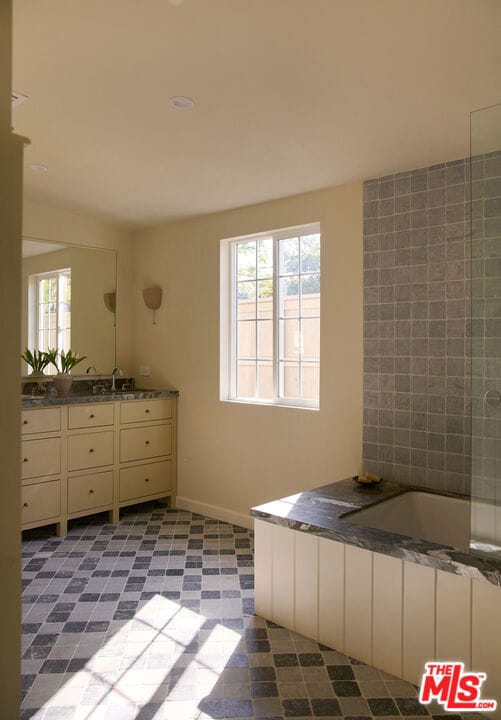 bathroom with vanity and a tub