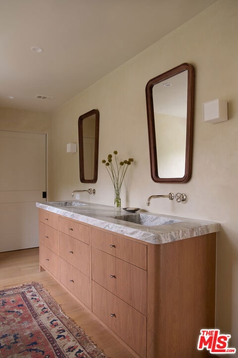 bathroom featuring hardwood / wood-style flooring and vanity