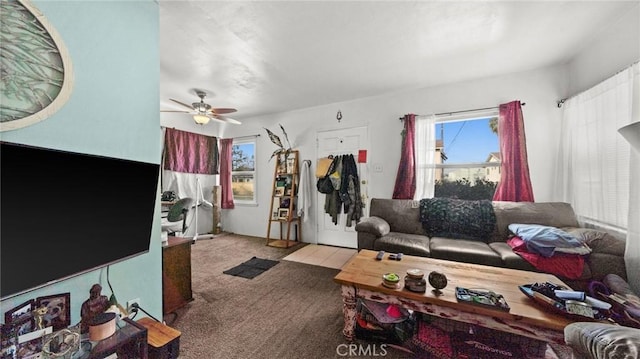 carpeted living room with ceiling fan