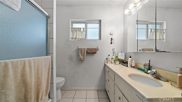 bathroom featuring vanity, a shower with shower door, tile patterned floors, and toilet