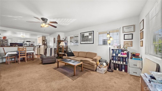 carpeted living room with ceiling fan