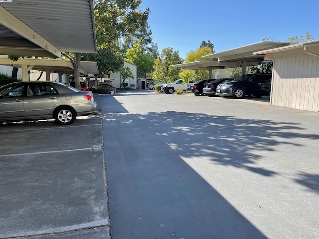 view of parking / parking lot featuring a carport