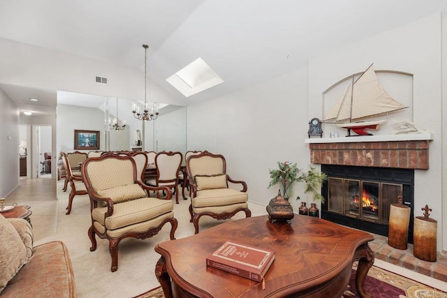 living room featuring an inviting chandelier, a fireplace, and vaulted ceiling with skylight