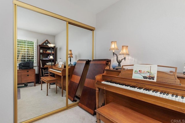 miscellaneous room featuring light colored carpet