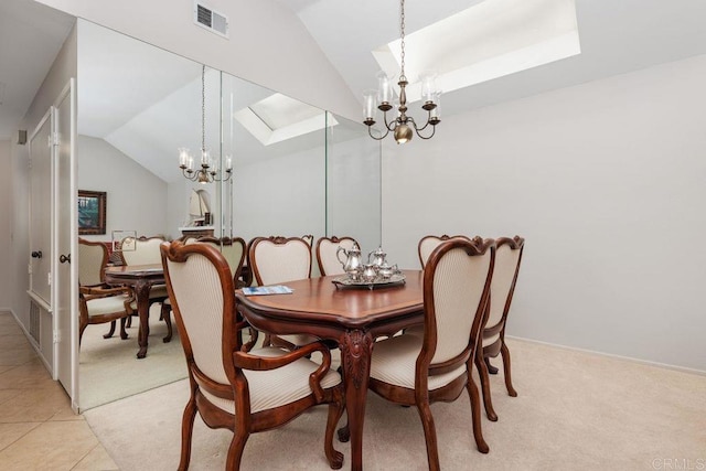 tiled dining room with vaulted ceiling and a notable chandelier