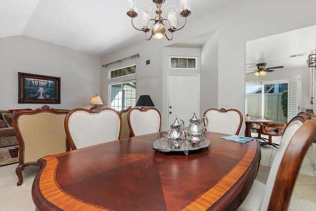 dining area with light tile patterned floors, ceiling fan with notable chandelier, and vaulted ceiling