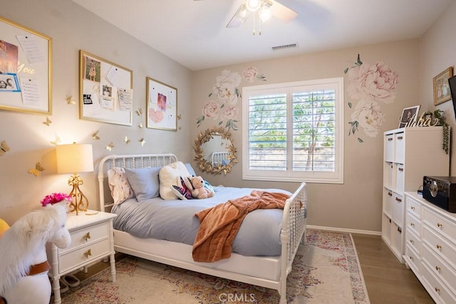 bedroom with dark hardwood / wood-style flooring and ceiling fan