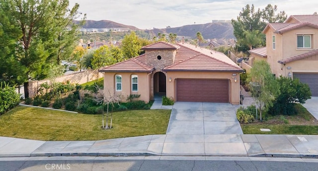 mediterranean / spanish home featuring a mountain view and a front lawn