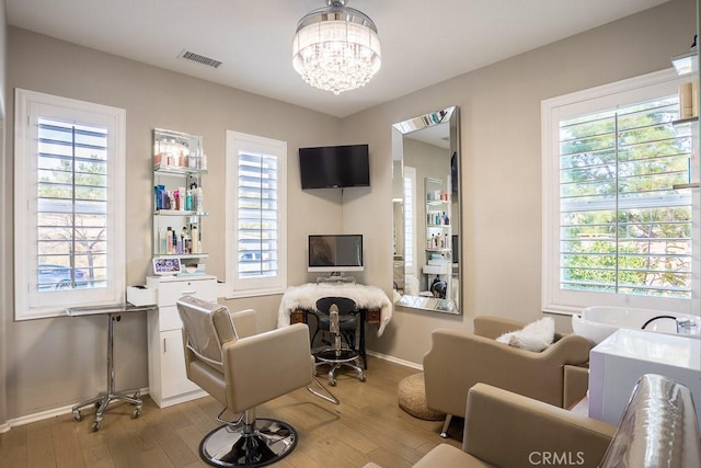 living room featuring an inviting chandelier and light hardwood / wood-style floors