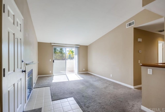 interior space with lofted ceiling and light colored carpet