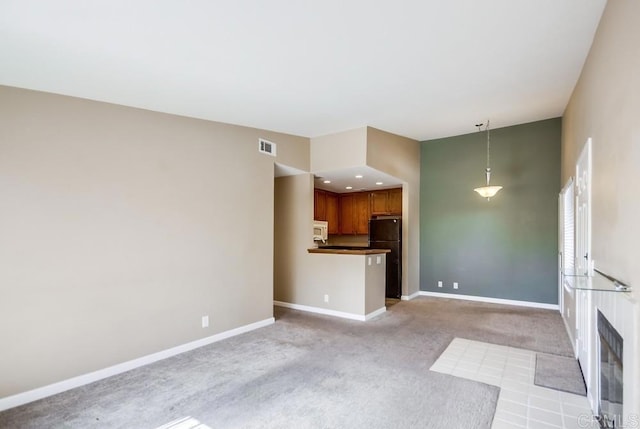 unfurnished living room with light carpet