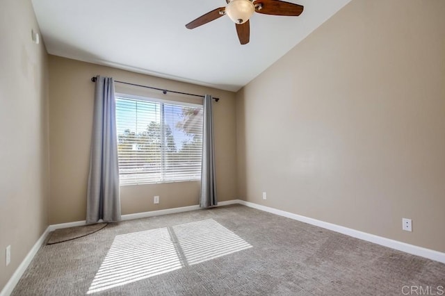 unfurnished room featuring light carpet, vaulted ceiling, and ceiling fan