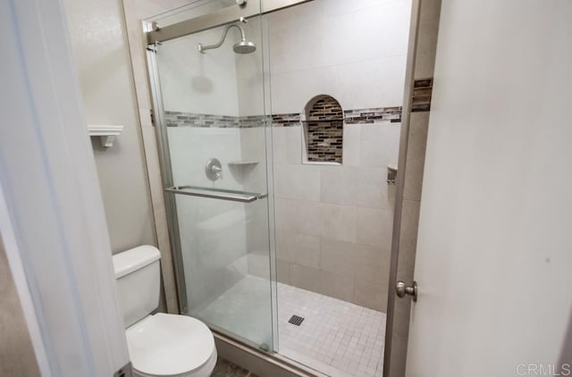 bathroom with walk in shower and toilet