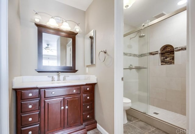 bathroom with tile patterned flooring, vanity, walk in shower, ceiling fan, and toilet