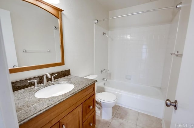 full bathroom with tile patterned flooring, vanity, tiled shower / bath combo, and toilet