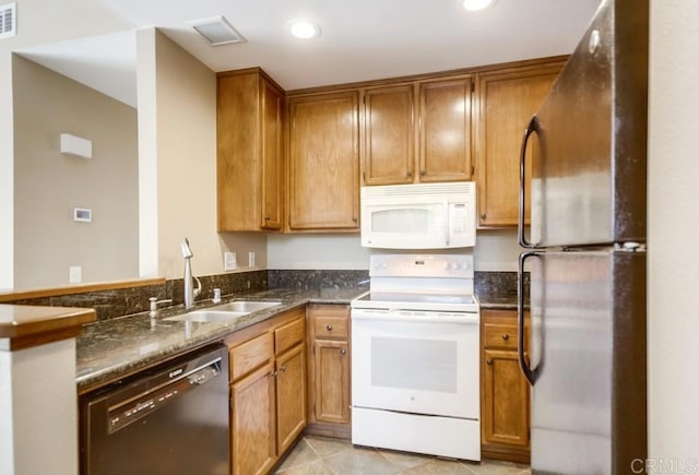 kitchen with sink, black appliances, and dark stone counters