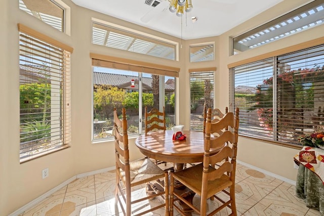 sunroom featuring ceiling fan