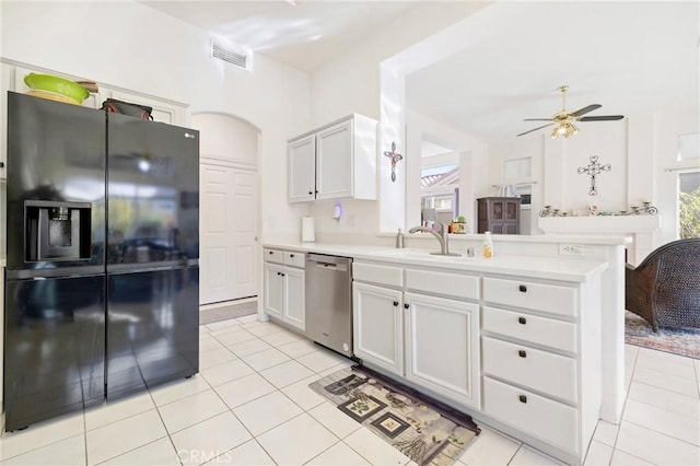 kitchen featuring sink, light tile patterned floors, white cabinets, black refrigerator with ice dispenser, and stainless steel dishwasher