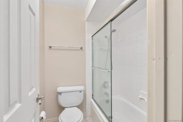 bathroom with enclosed tub / shower combo and toilet