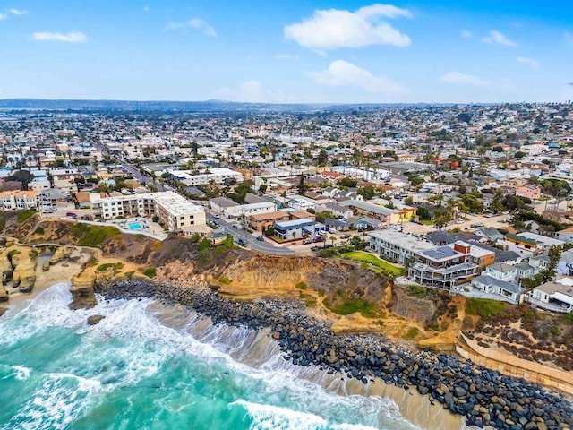 aerial view with a water view and a beach view