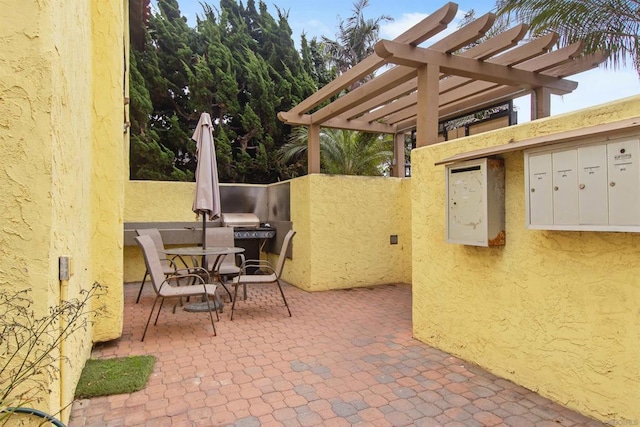 view of patio / terrace with area for grilling and a pergola