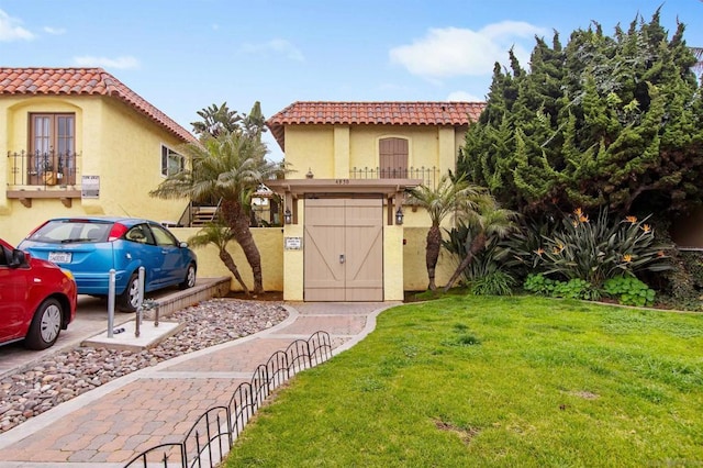 mediterranean / spanish-style home featuring a front yard