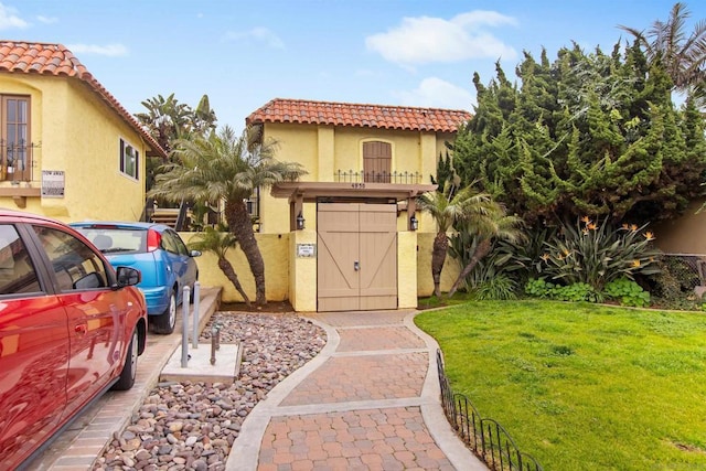 mediterranean / spanish house with a front yard