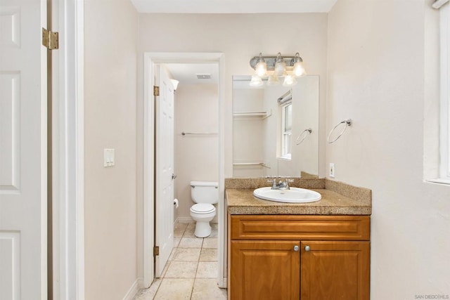 bathroom featuring tile patterned floors, vanity, and toilet