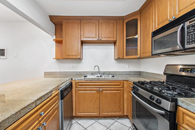 kitchen featuring sink, light tile patterned flooring, and appliances with stainless steel finishes