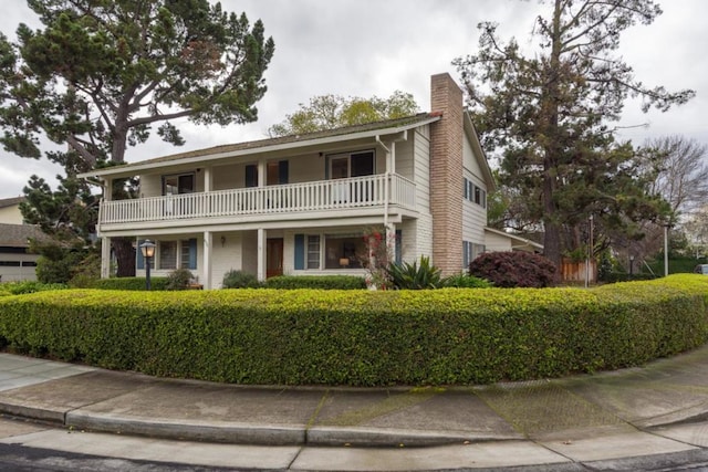 view of front of house featuring a balcony