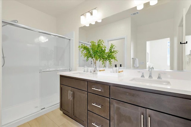 bathroom with vanity and a shower with shower door